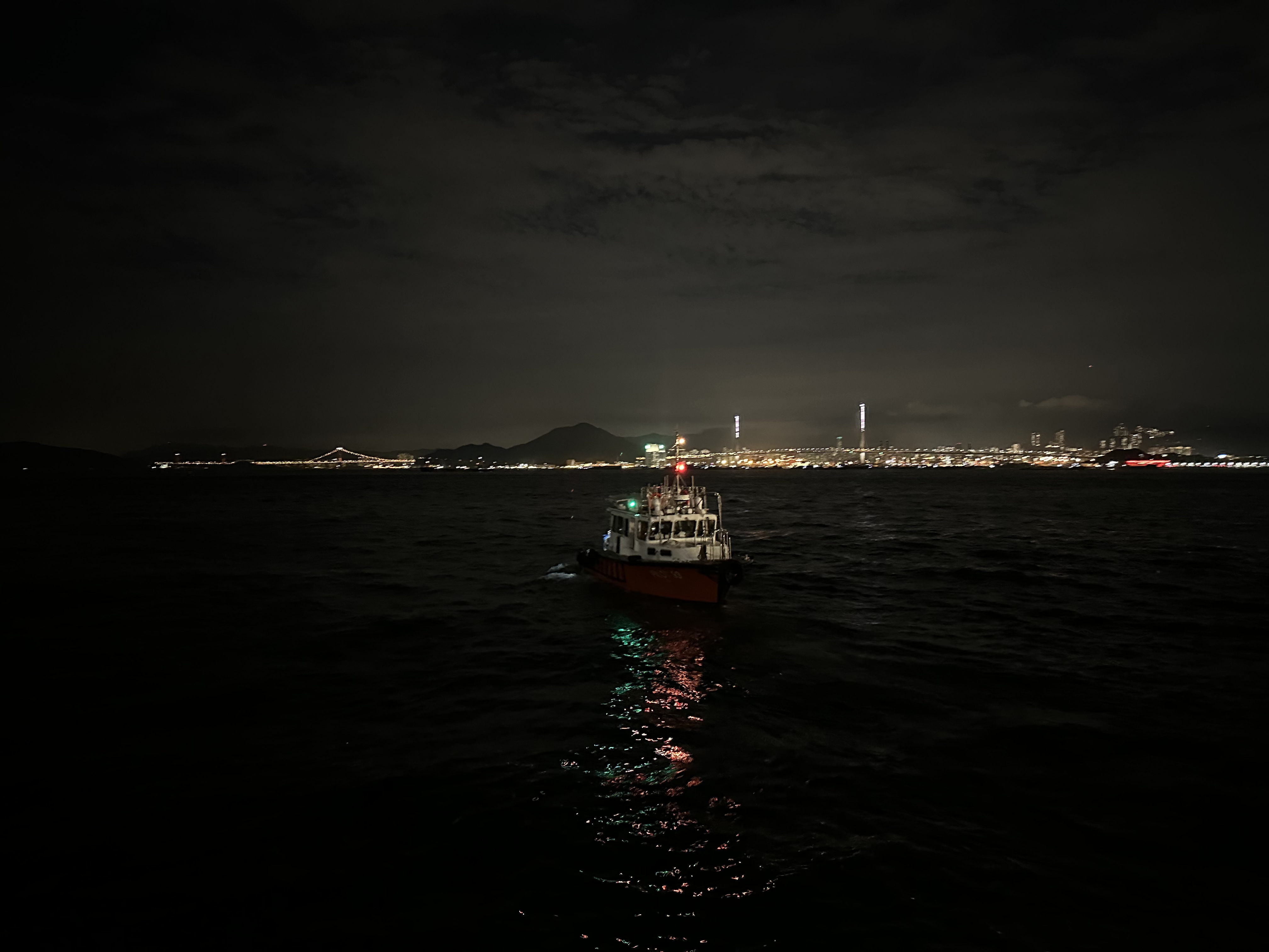 Boats moored at Kennedy Town waterfront at night.